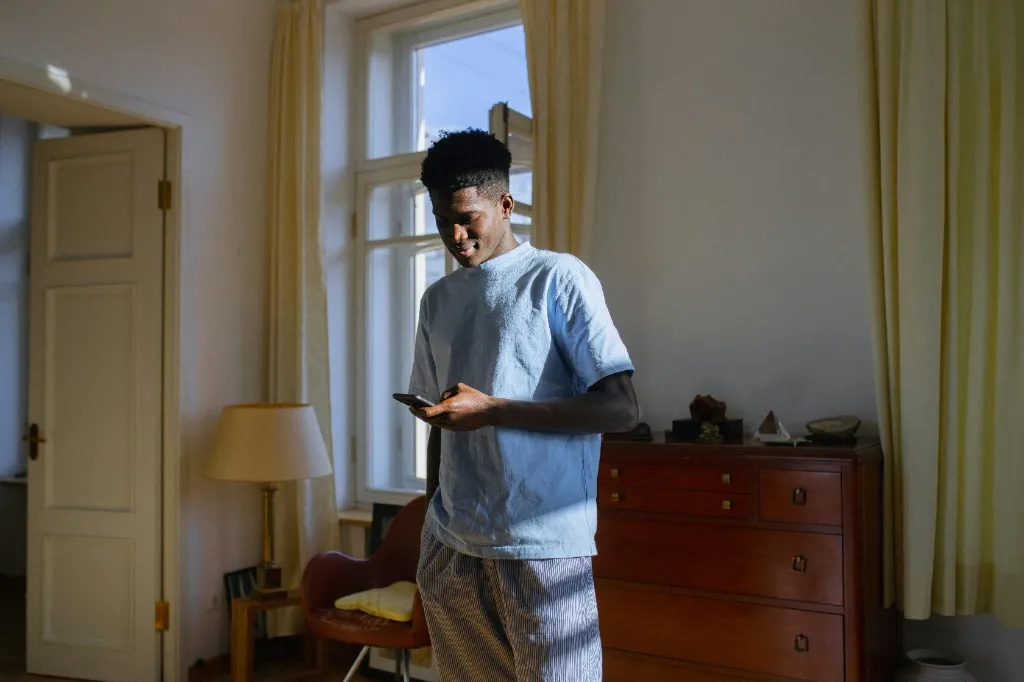 Student using their phone in a comfortable home setting