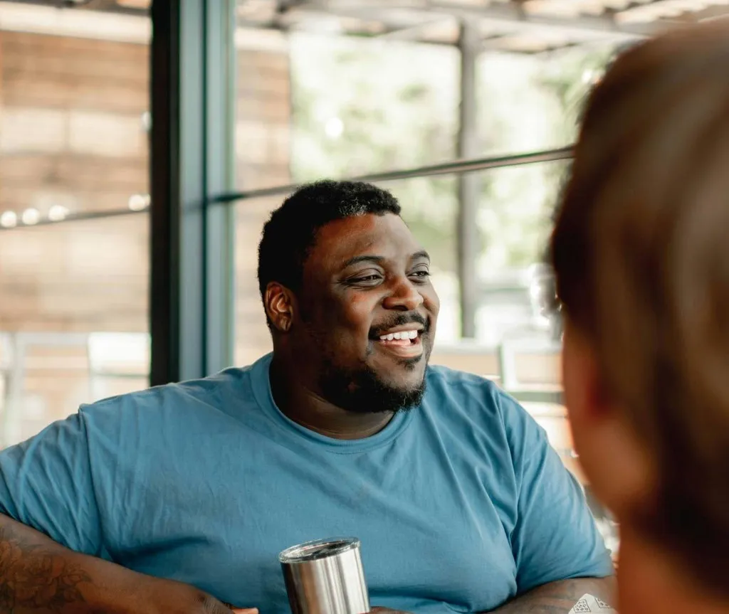Two people talking over coffee